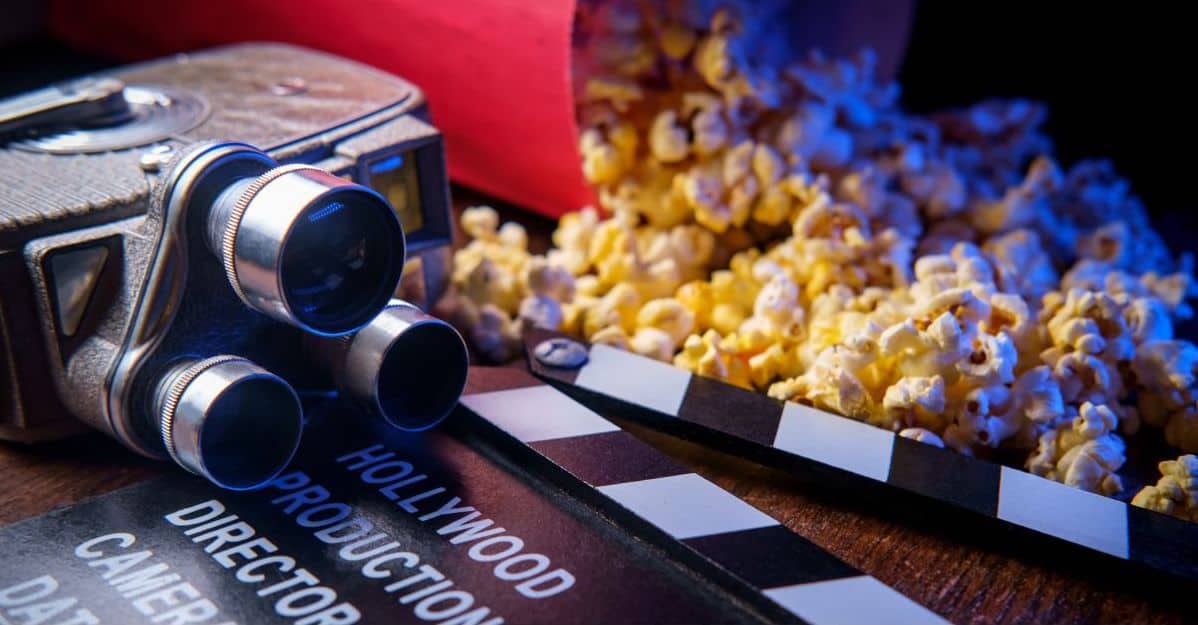 A old fashioned movie camera and a spilled bag of popcorn at African movies