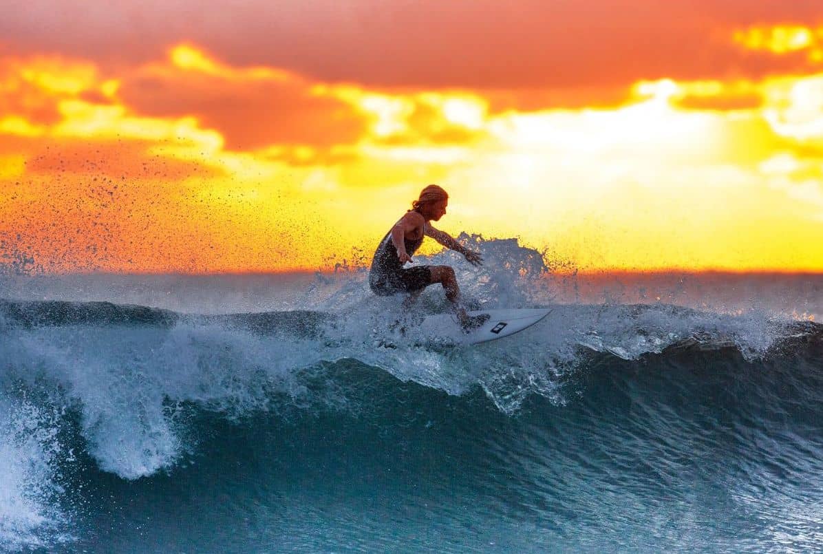 surfer on the waves at sunset