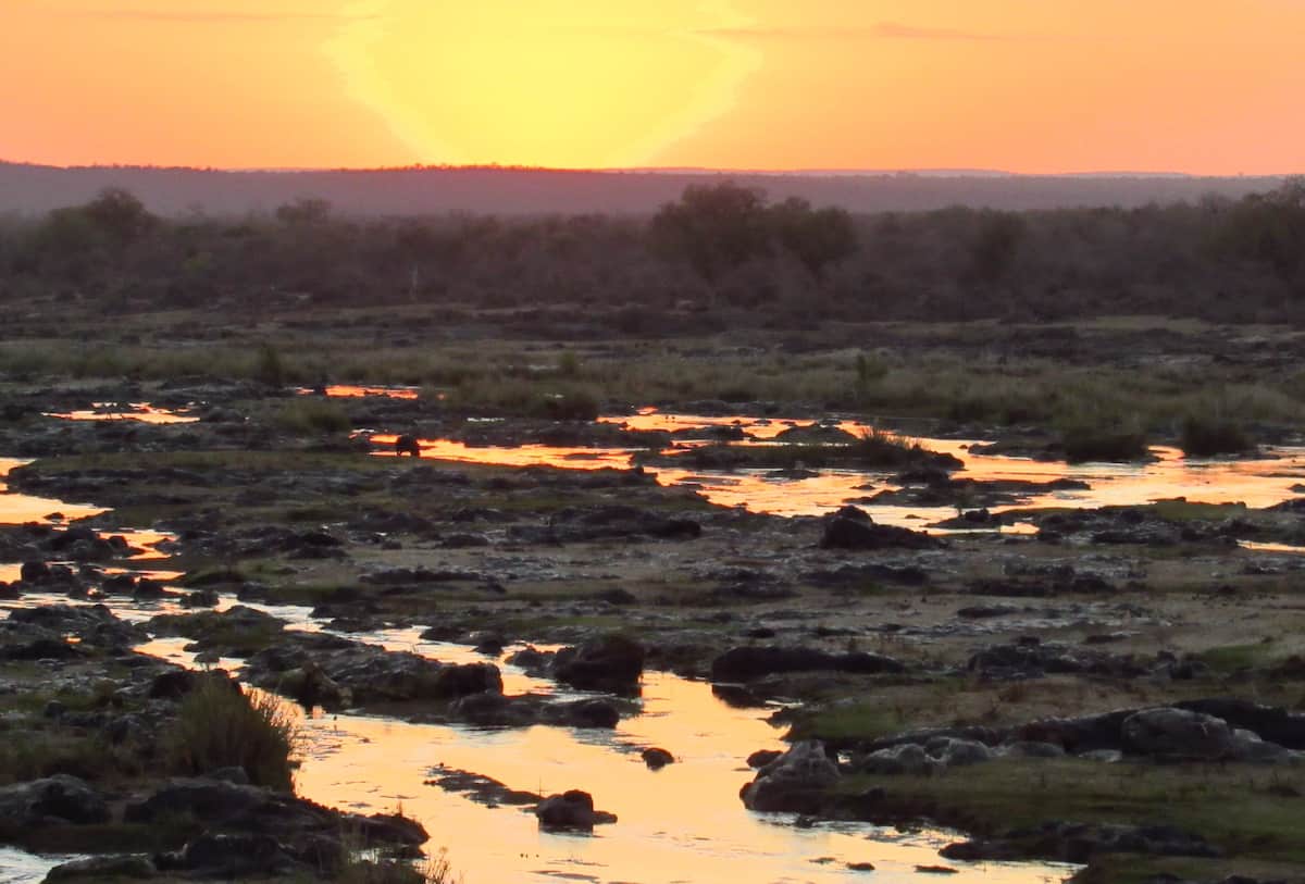 South African sunset over a partially dry lake in Kruger National Park.