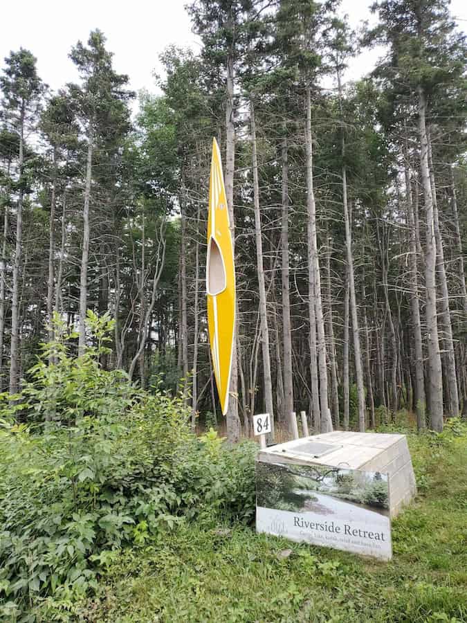 Riverside Retreat entrance, marked by a yellow kayak standing on end.